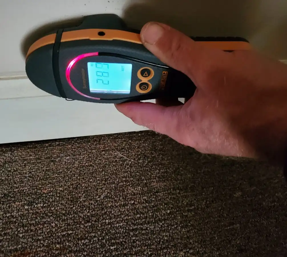 Moisture detection at baseboard during Storm Damage Restoration in Lincoln